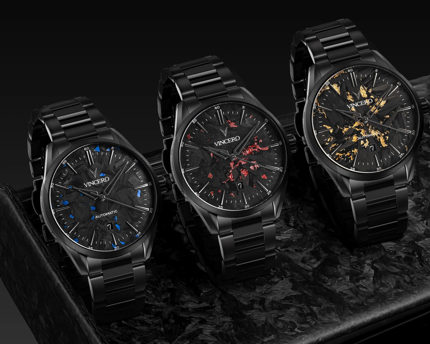 Three black wristwatches with detailed faces on a dark background