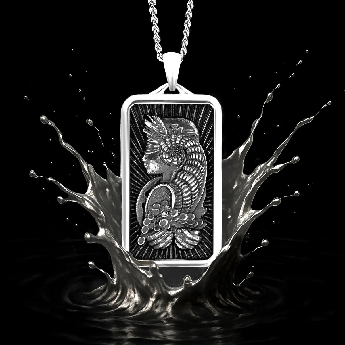 Silver pendant with a design of a cat and flowers, surrounded by water splashes on a black background