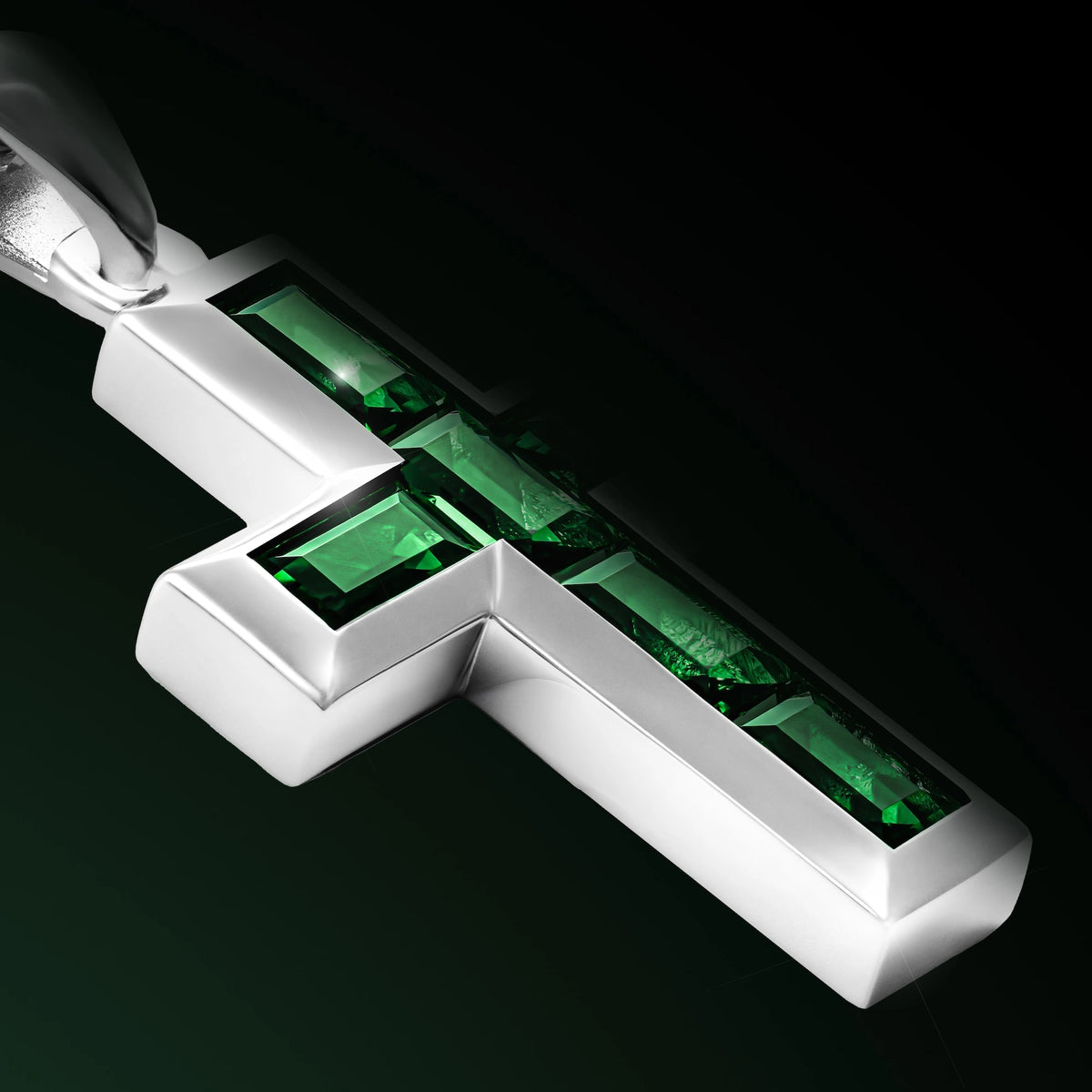 Silver cross pendant with red stones on a chain against a black background