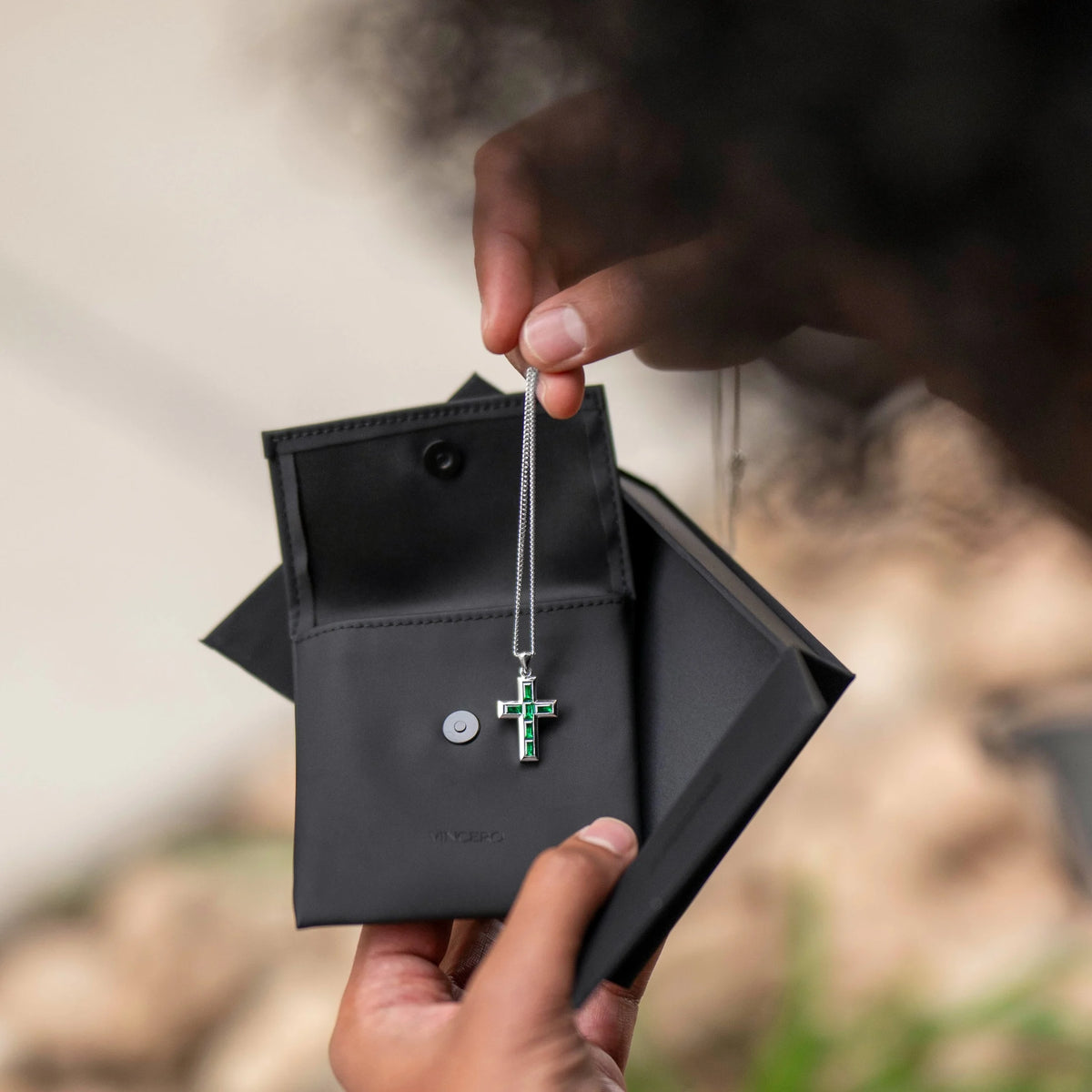 Silver cross pendant with red stones on a chain 