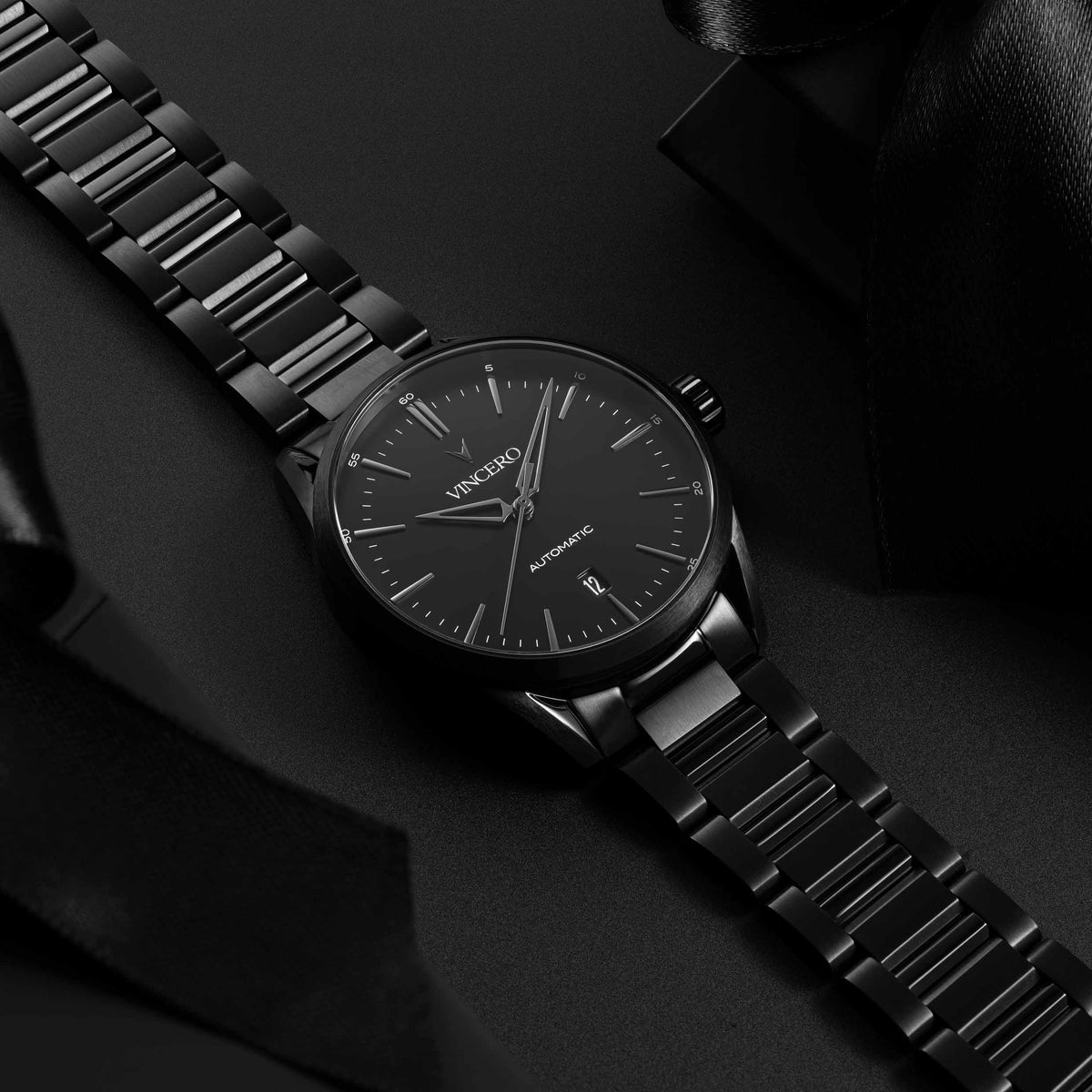 Black wristwatch with a detailed face on a dark background