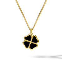 Gold necklace with a black four-leaf clover pendant on a white background