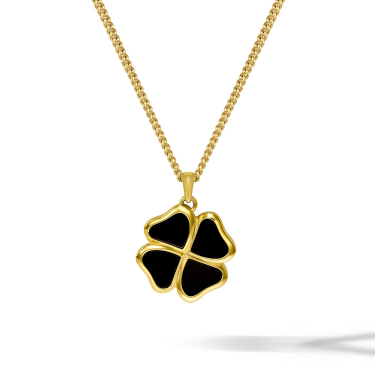 Gold necklace with a black four-leaf clover pendant on a white background