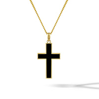 Black cross pendant on a gold chain against a white background