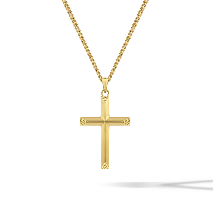 Gold cross pendant on a chain against a white background