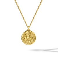 Gold necklace with a round pendant on a white background