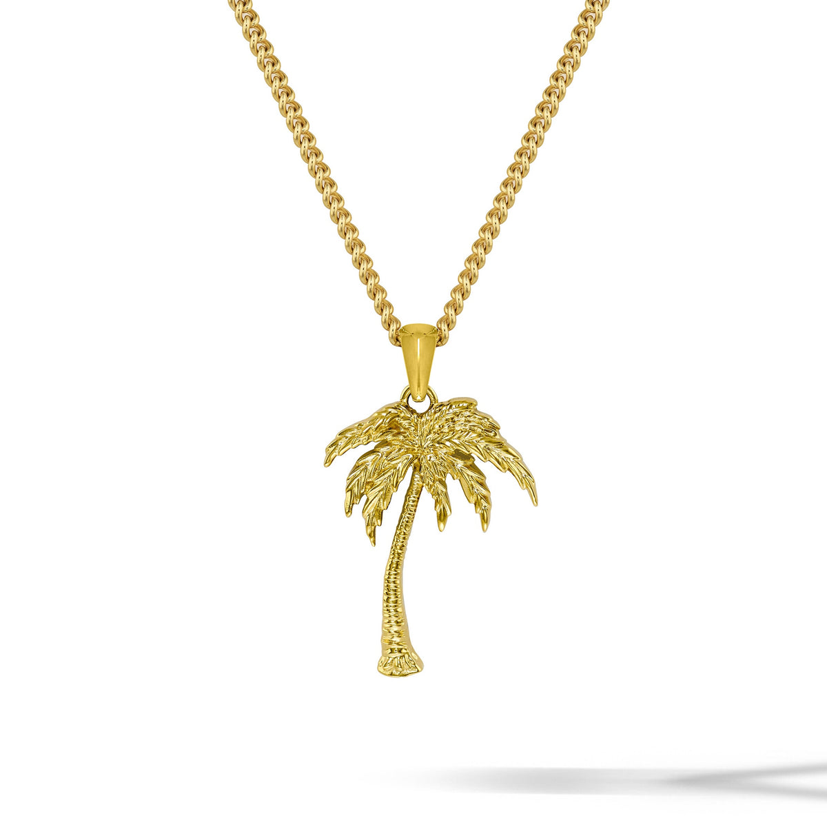 Gold palm tree necklace on a white background