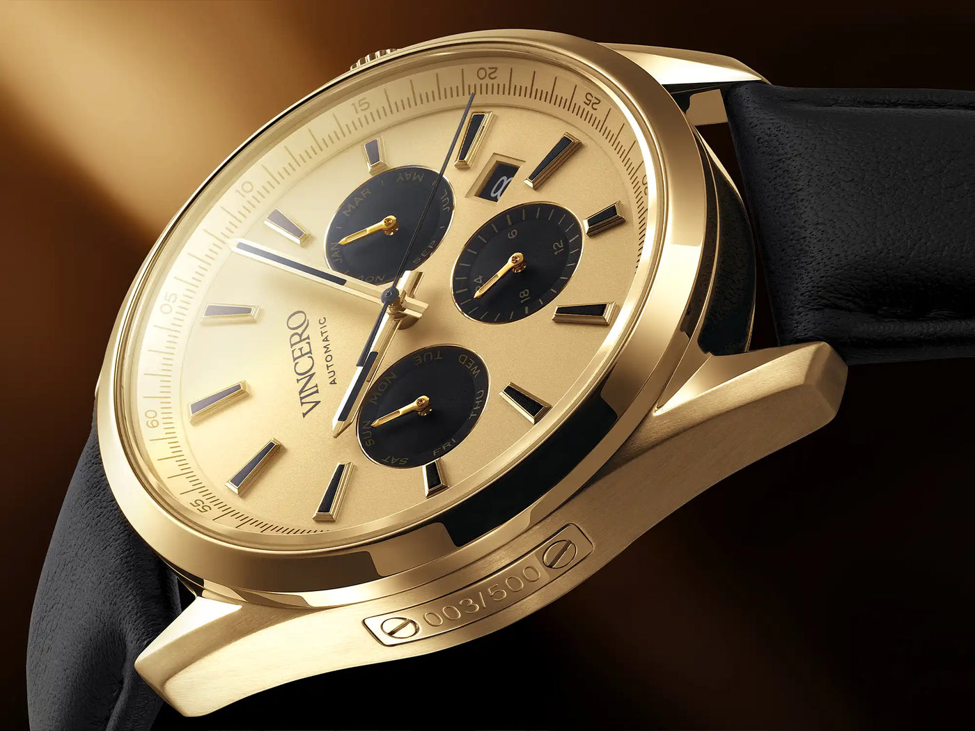 Gold wristwatch with black face on a dark background