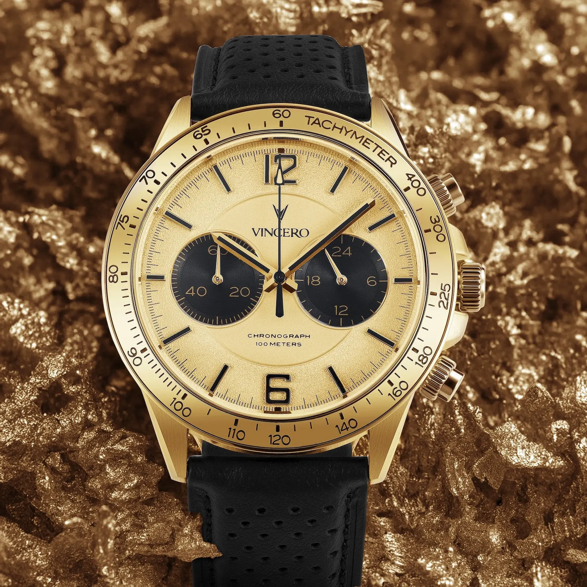 Gold wristwatch with black strap on a textured brown background