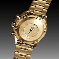Gold watch with brand logo on a dark background