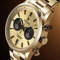 Gold wristwatch with visible brand name on a reflective surface