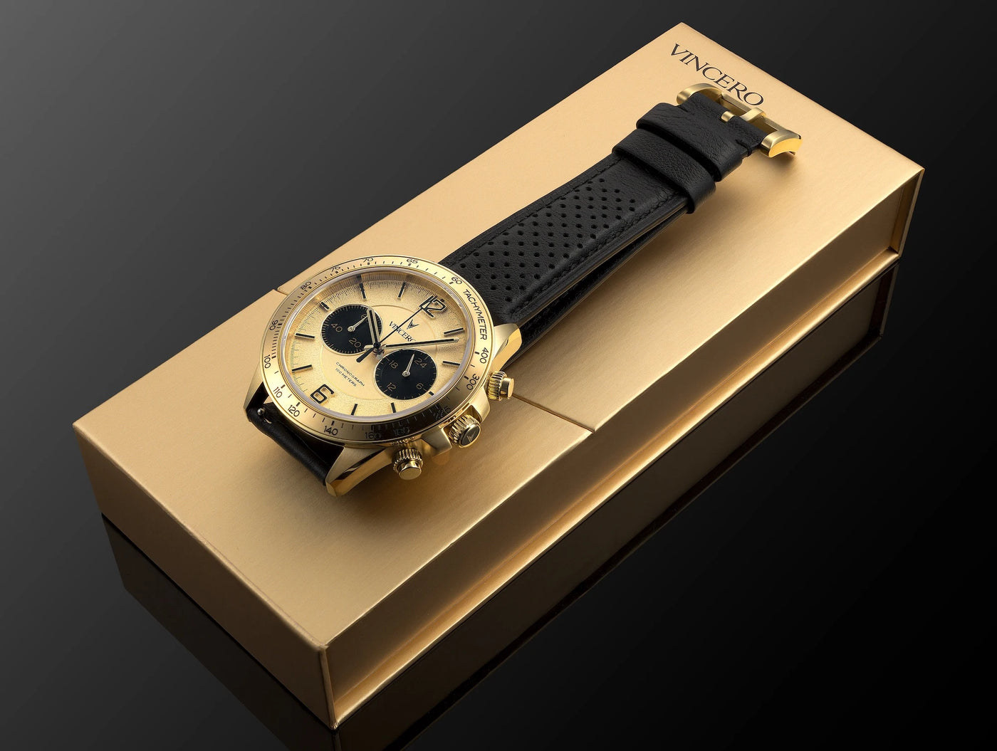 Luxury watch with black strap on a gold box, featuring the brand 'Vincero'.