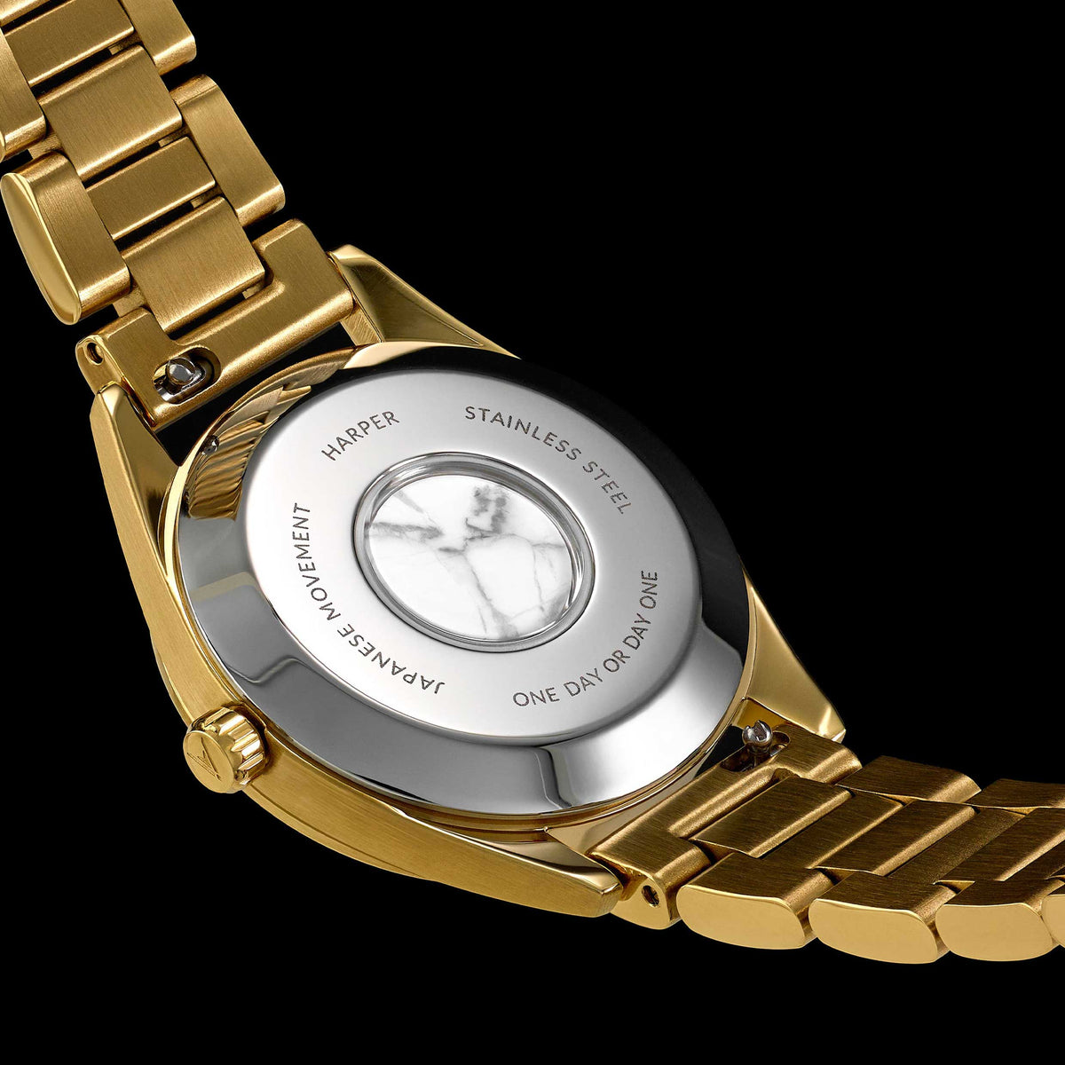 Gold watch with a visible movement mechanism on a black background