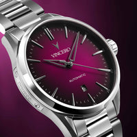 Silver wristwatch with a maroon dial on a purple background