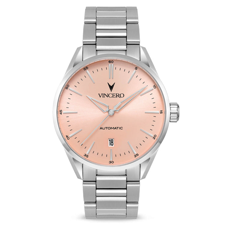 A silver-toned Vincero watch with a pink dial and a date display, featuring a stainless steel bracelet.