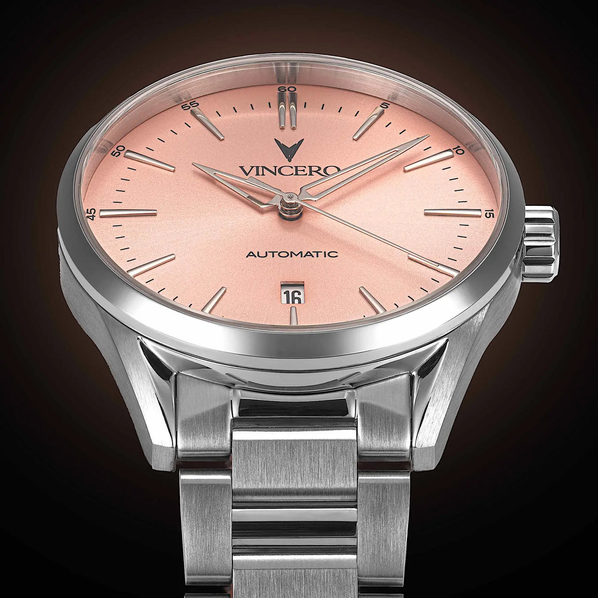 Silver watch with a pink face on a dark background