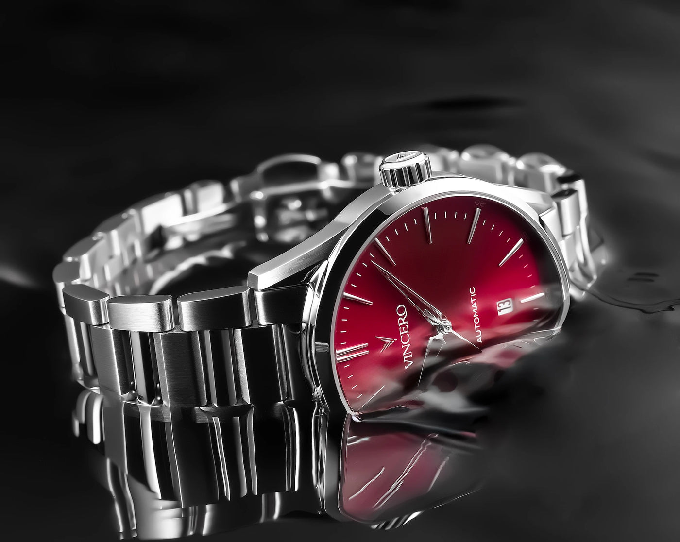 Silver watch with a red face on a black background