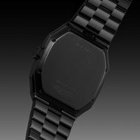 Black watch with checkered strap on a gradient background