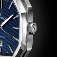 Close-up of a silver watch with a blue face on a dark background