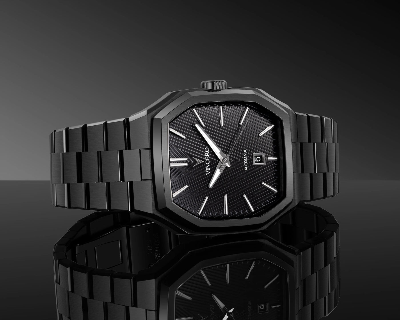 Black wristwatch with a reflective surface on a dark background