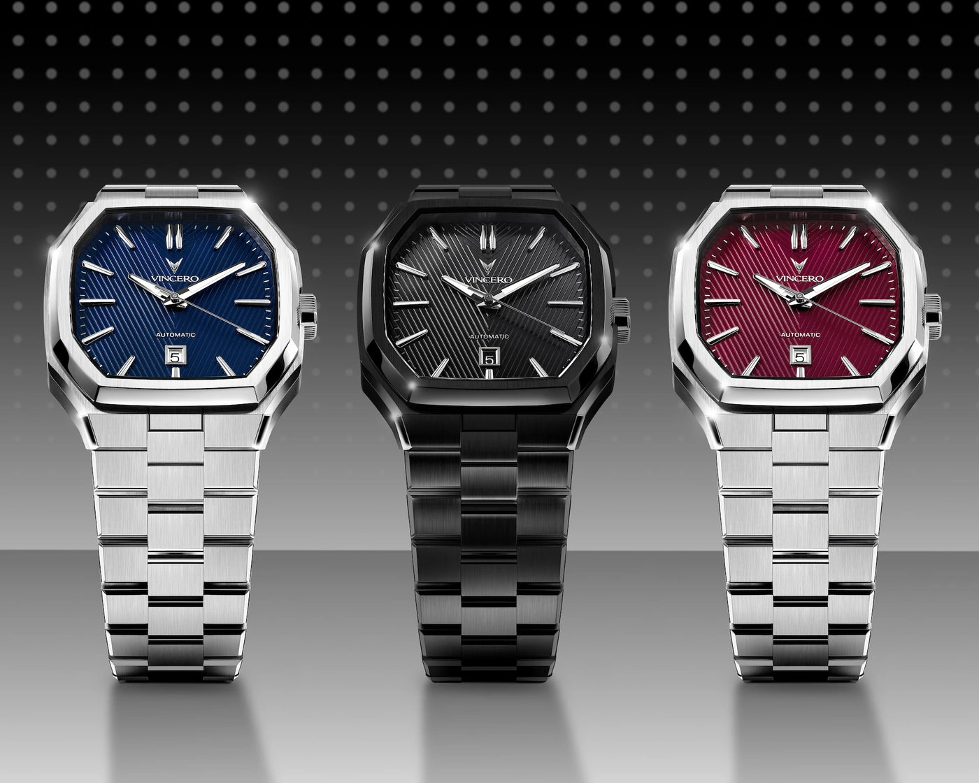 Three watches with different colored faces on a reflective surface with a dark background
