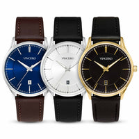 Three VINCERO men's analog watches with leather straps are lined up side by side on a white background. From left to right: a blue dial with a brown strap, a white dial with a black strap, and a black dial with a gold strap.
