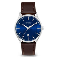 A VINCERO men's analog watch featuring a deep blue sunburst dial, silver-tone stainless steel case, and a brown leather strap with matching contrast stitching.