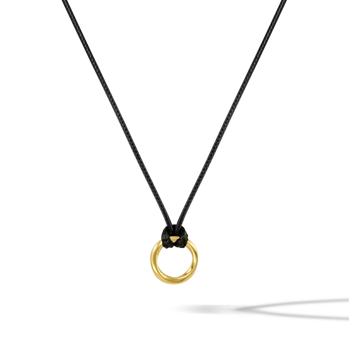 Gold ring pendant on a black cord against a white background