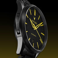 Watch with black face and yellow hands on a dark background