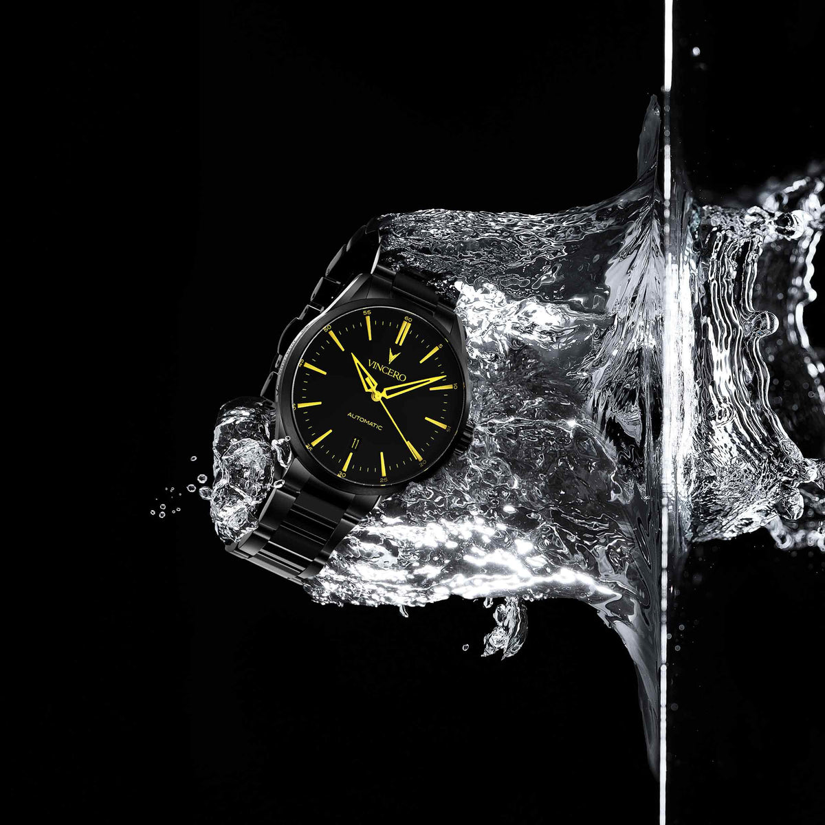Watch emerging from a block of ice with water splashes on a black background