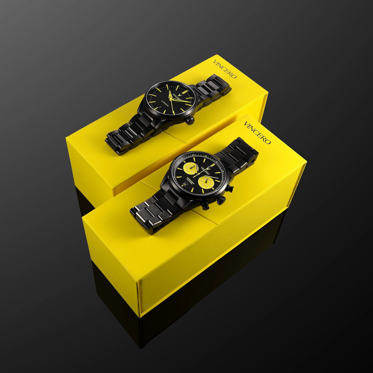 Two black watches on yellow stands with 'Vince Camuto' branding against a dark background
