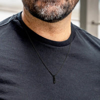 Man wearing a black shirt with a black zipper detail
