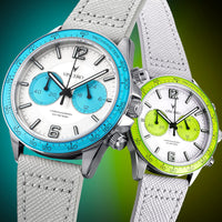 Two watches with blue and green faces on white straps against a gradient background