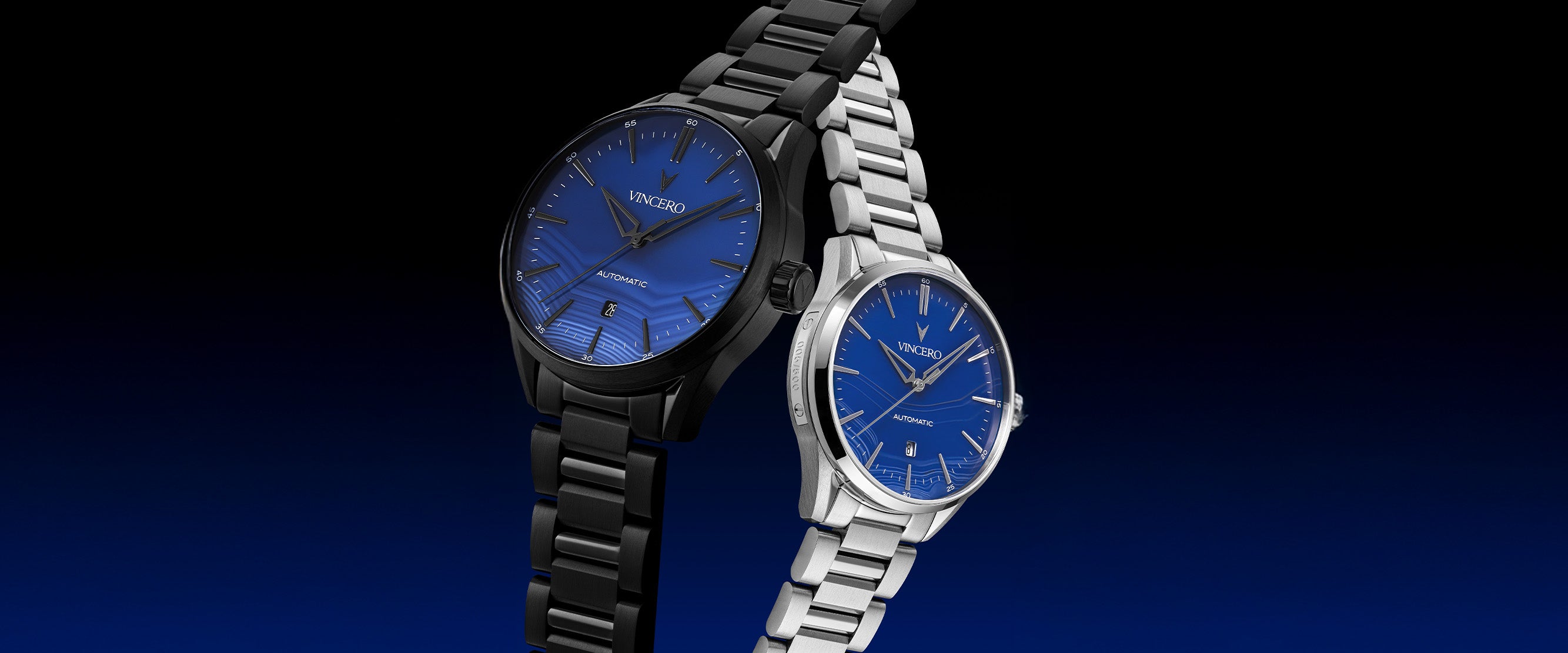 Two watches, one black and one silver, with blue faces on a dark background