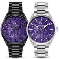Two Vincero automatic wristwatches with purple marbled dials, shown side by side. The watch on the left has a black stainless steel case and link bracelet, while the watch on the right has a silver stainless steel case and link bracelet.