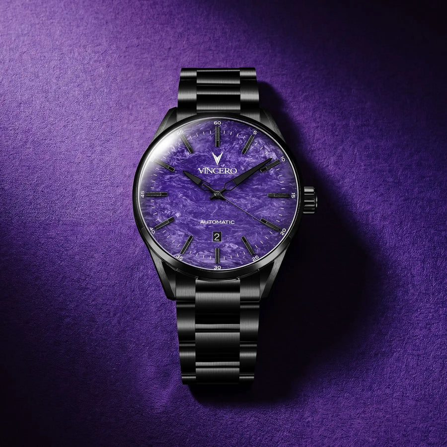 A VINCERO automatic watch with a black metal bracelet and case, featuring a textured purple dial, set against a matching purple textured background.