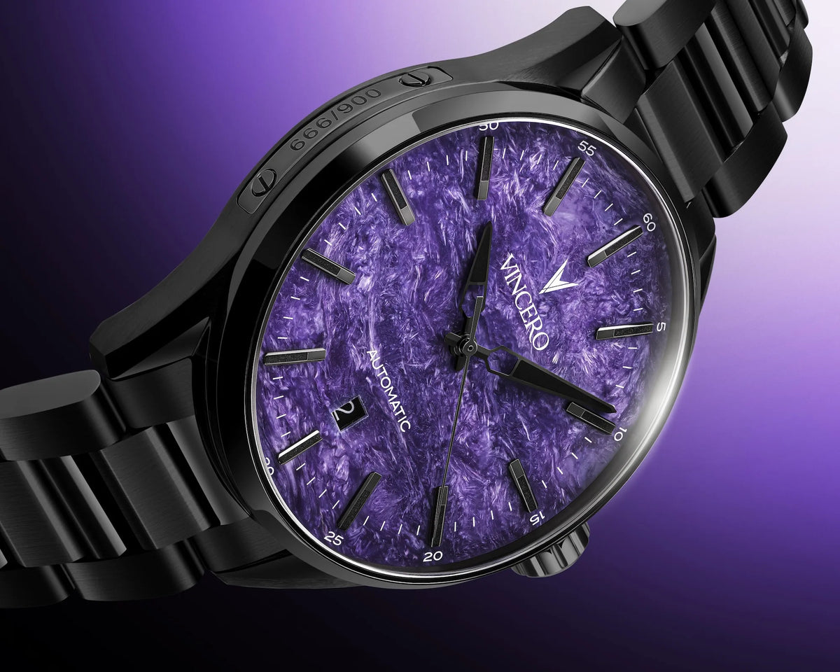 A close-up of a wristwatch with a black metal bracelet and case, featuring a textured purple dial with black markers and hands. The brand name 'VINCERO' is visible on the dial.