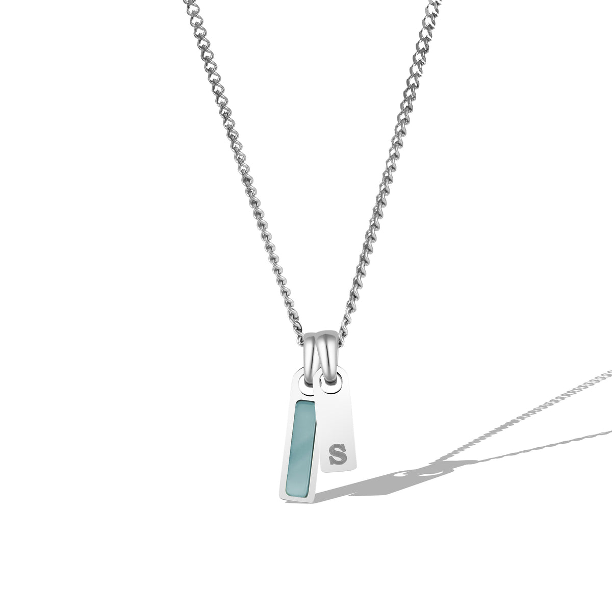 A silver necklace with a rectangular tag pendant featuring a birthstone and a chain link.