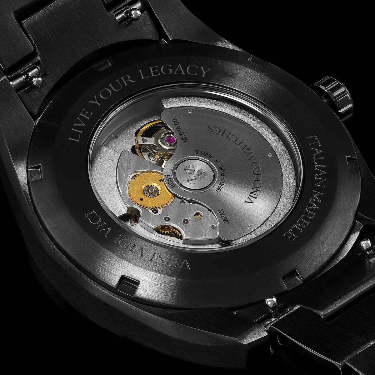 Close-up of a watch mechanism with 'Vincent Peric' branding on a black background
