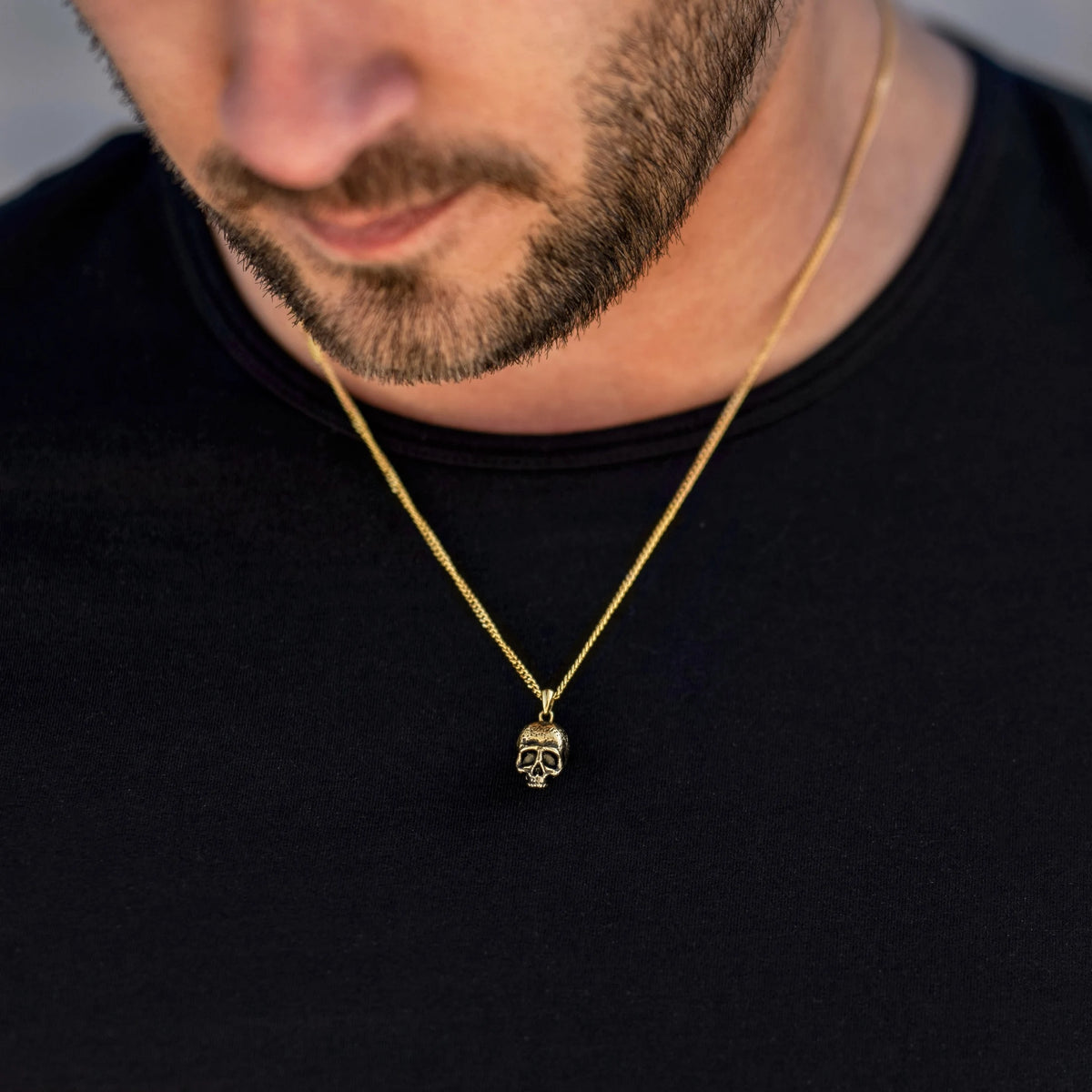 Gold chain necklace with a skull pendant 