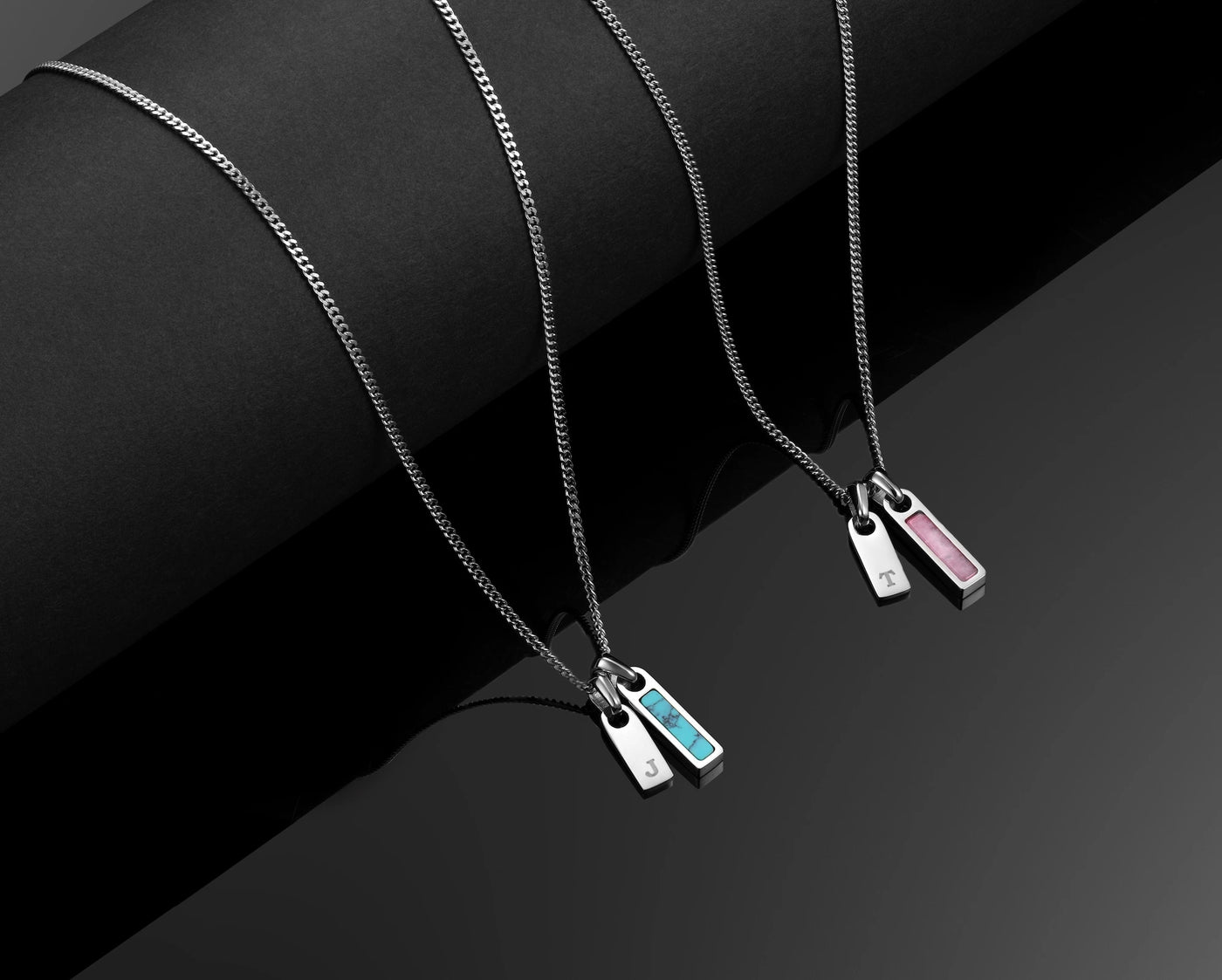 Necklace with three colorful pendants on a black background
