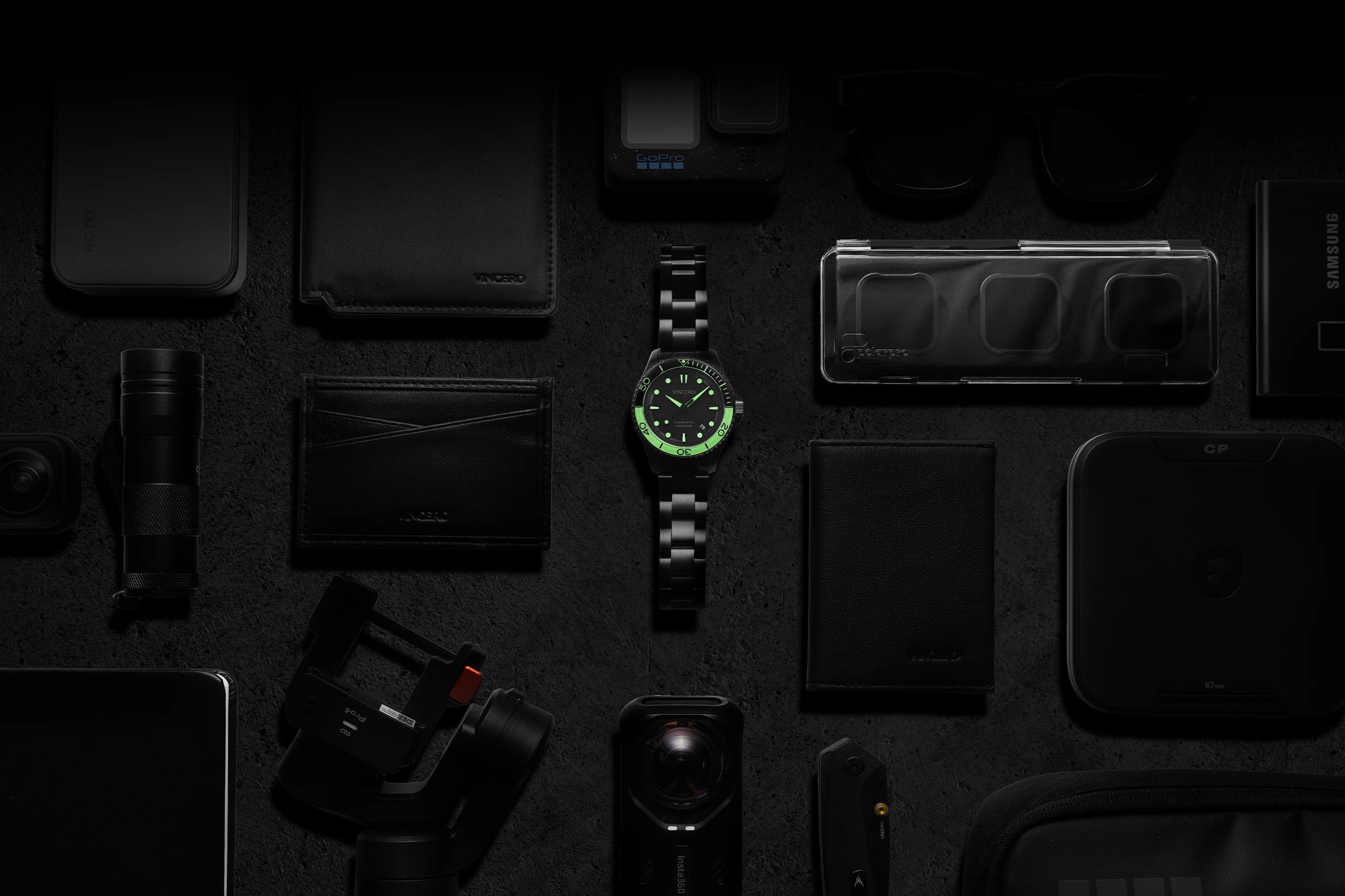 Collection of electronic devices and accessories on a dark surface