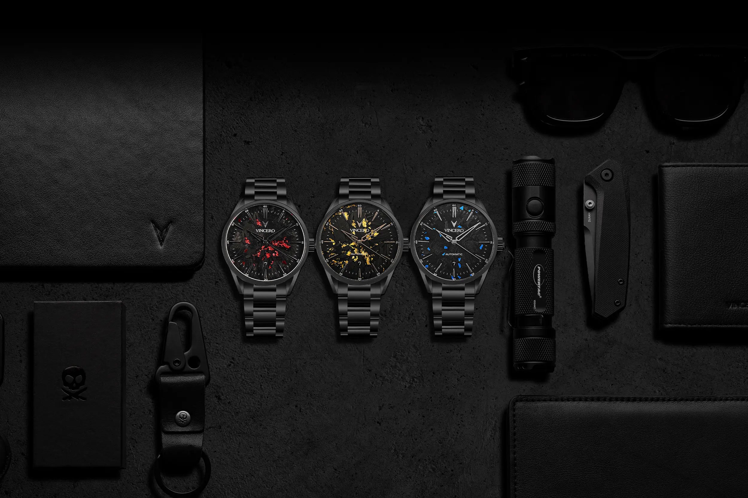 Three black watches with different face designs on a dark textured surface.