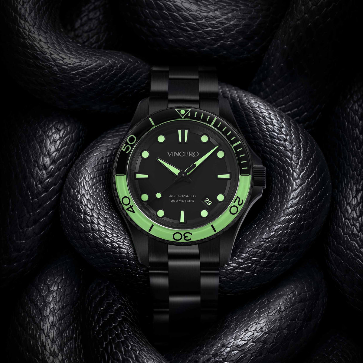 Black wristwatch with green accents on a dark textured background