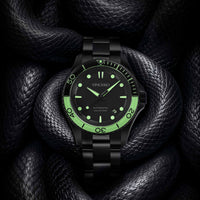 Black wristwatch with green accents on a dark textured background