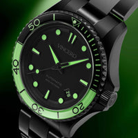 Black and green watch with 'Vincero' branding on a dark background