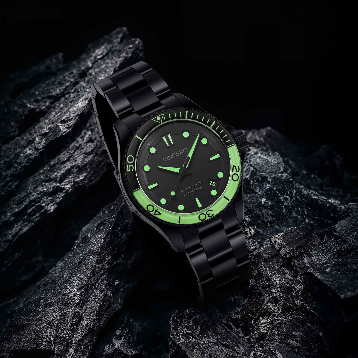 Black watch with green face on a dark stone background