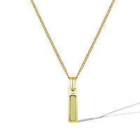 Gold necklace with a rectangular pendant on a white background