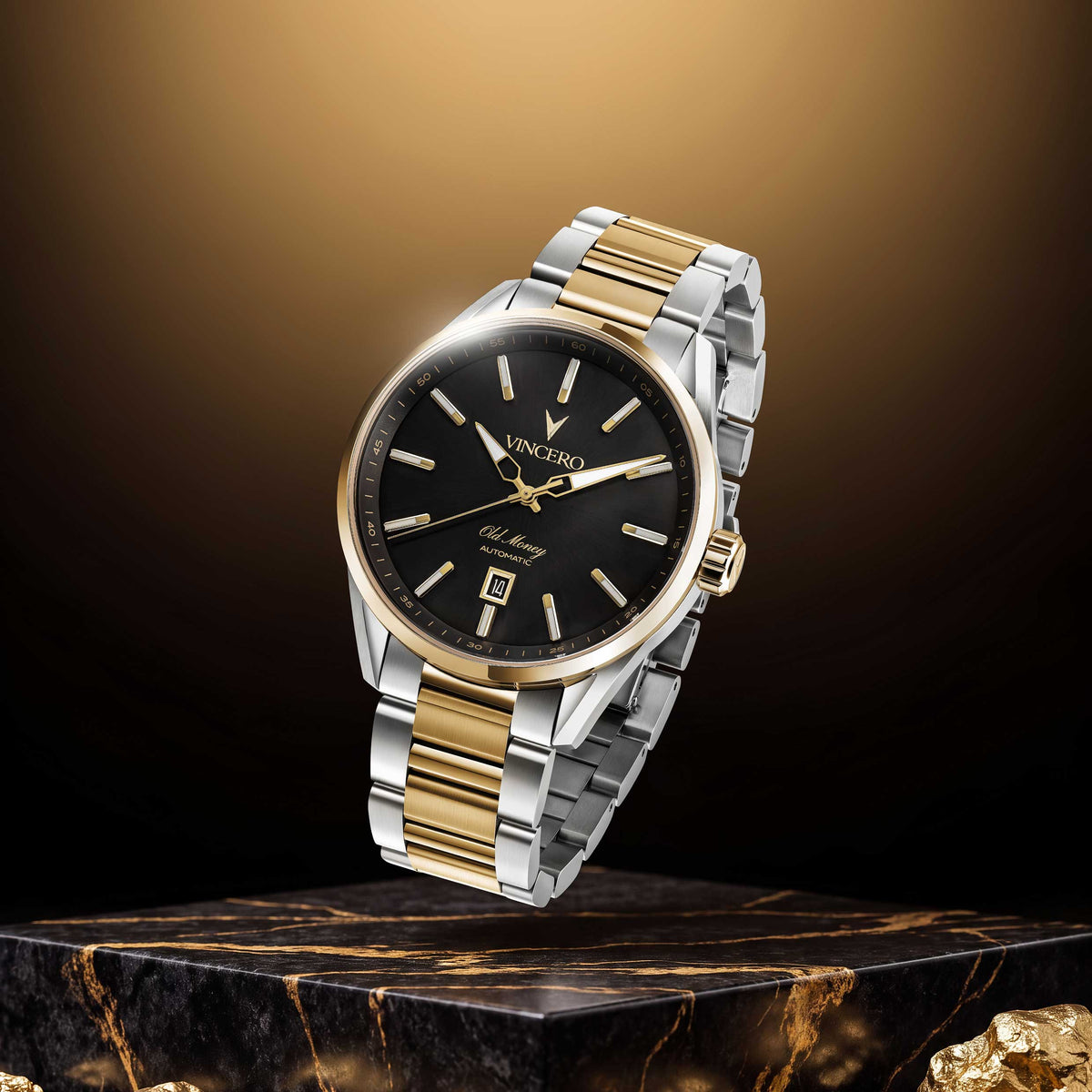 A luxury two-tone wristwatch with a black dial, gold and silver stainless steel case and bracelet, floating above a dark marble pedestal with gold accents.