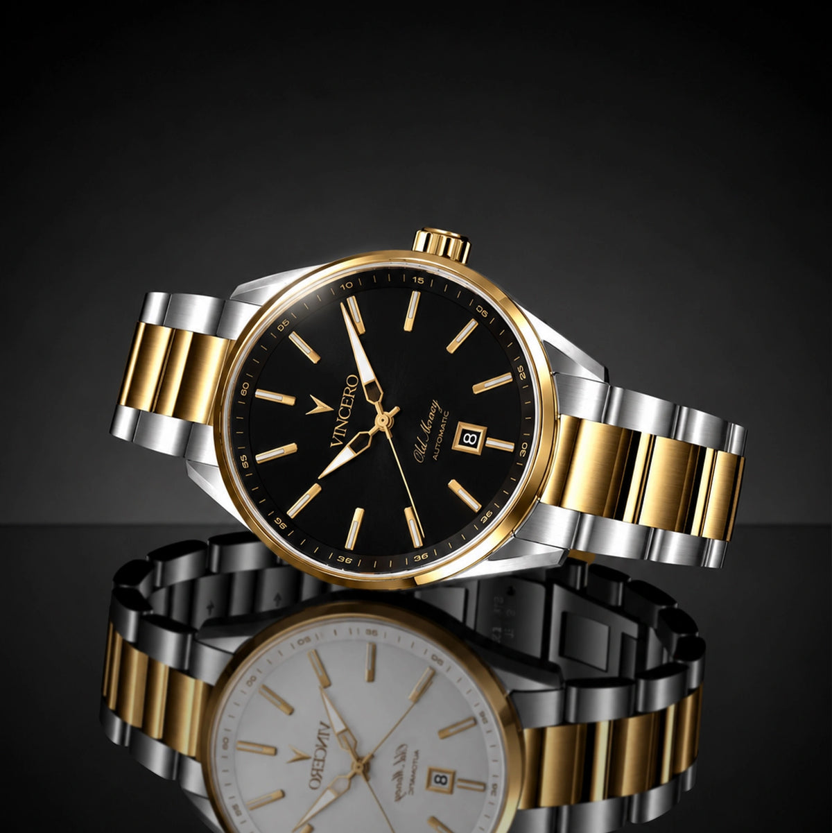 A two-tone stainless steel and gold wristwatch with a black dial, shown in a clean studio composition with its reflection visible below on a dark gradient background.
